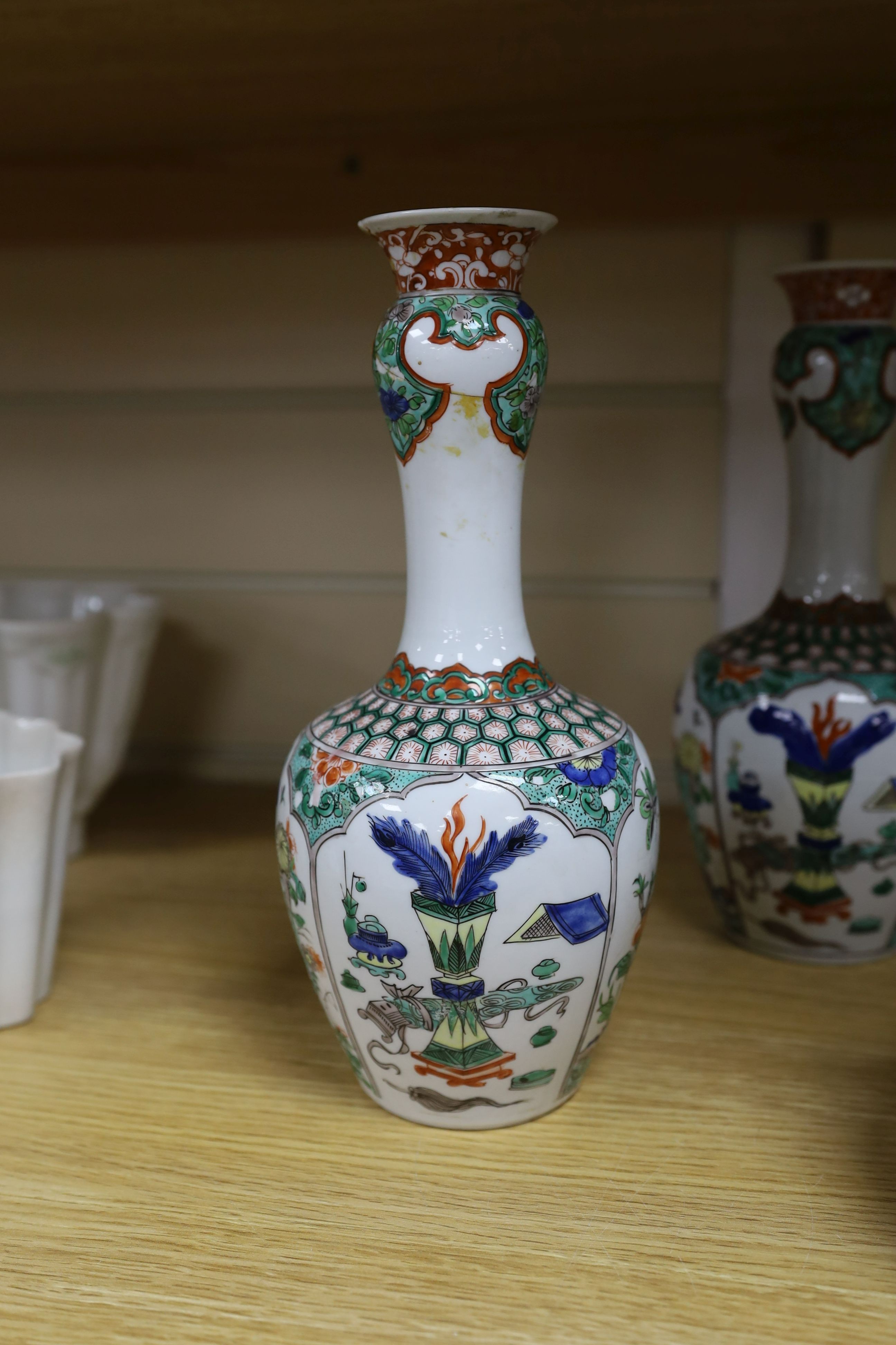 A pair Samson of Paris vases in the Chinese famille verte style and a Chinese Qianlong famille rose garlic neck vase with blue panelling motif, tallest 26cm